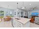 Bright kitchen island with stainless steel dishwasher offers views of the waterfront dining and living areas at 276 Saint Lucia Dr # 101, Bradenton, FL 34209