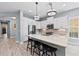 Modern kitchen featuring stainless steel appliances, island with stools, and bright lighting at 276 Saint Lucia Dr # 101, Bradenton, FL 34209