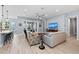 Open-concept living room with tile floors, stylish furniture, and water views at 276 Saint Lucia Dr # 101, Bradenton, FL 34209