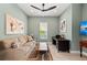 Inviting living room features a comfortable couch, ceiling fan, and bright artwork at 276 Saint Lucia Dr # 101, Bradenton, FL 34209