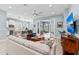 Cozy open-concept living room with a view of the water and a bright, modern kitchen at 276 Saint Lucia Dr # 101, Bradenton, FL 34209