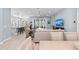 Spacious open-concept living room with a view of the water and a bright, modern kitchen at 276 Saint Lucia Dr # 101, Bradenton, FL 34209