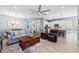 Bright open-concept living room featuring a ceiling fan, a comfortable sofa, and an adjacent modern kitchen at 276 Saint Lucia Dr # 101, Bradenton, FL 34209