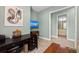 Inviting living room features a mounted TV, desk, and attached bathroom at 276 Saint Lucia Dr # 101, Bradenton, FL 34209