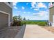 View of parking area, landscaping, and water in the distance at 276 Saint Lucia Dr # 101, Bradenton, FL 34209