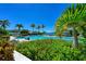 Lush tropical foliage surrounding community pool and lounge chairs at 276 Saint Lucia Dr # 101, Bradenton, FL 34209