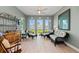 Cozy sitting area with wicker furniture and natural light streaming through multiple windows with water views at 276 Saint Lucia Dr # 101, Bradenton, FL 34209