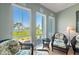 Cozy sitting area with wicker furniture enjoys sunny water views at 276 Saint Lucia Dr # 101, Bradenton, FL 34209