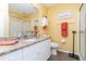 Bright bathroom with granite countertop, white cabinets, and a glass-enclosed shower stall at 2801 Dalhart Ave, North Port, FL 34286