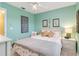Comfortable bedroom featuring a queen bed, side table, and nautical decor at 2801 Dalhart Ave, North Port, FL 34286