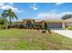 Charming one-story home featuring manicured landscaping, a screened entry, and an attached garage at 2801 Dalhart Ave, North Port, FL 34286
