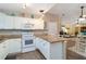 Bright kitchen with white cabinets, stone countertops, and modern appliances at 2801 Dalhart Ave, North Port, FL 34286