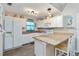 Bright kitchen featuring white cabinets, stone countertops, and modern appliances at 2801 Dalhart Ave, North Port, FL 34286