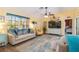 Inviting living room with bright walls, a ceiling fan, and comfortable seating arrangement at 2801 Dalhart Ave, North Port, FL 34286