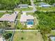 Aerial view of a home featuring a screened-in pool and patio area within a fenced backyard at 2801 Dalhart Ave, North Port, FL 34286