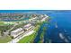 Scenic aerial view of waterfront property and golf course with the condo complex circled in white at 3070 Grand Bay Blvd # 644, Longboat Key, FL 34228
