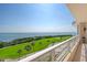 Condo balcony with a beautiful view overlooking a golf course and the sea at 3070 Grand Bay Blvd # 644, Longboat Key, FL 34228