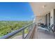 Balcony featuring a glass railing, tiled floor, and comfortable furniture offering stunning panoramic views at 3070 Grand Bay Blvd # 644, Longboat Key, FL 34228