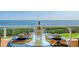 Balcony with gulf view, seating and table set for dining with table setting for two including a bottle of wine at 3070 Grand Bay Blvd # 644, Longboat Key, FL 34228