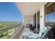 Balcony featuring a glass railing, tiled floor, and comfortable furniture offering stunning panoramic views at 3070 Grand Bay Blvd # 644, Longboat Key, FL 34228