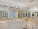 Bright bathroom features dual vanity, large tub and shower at 3070 Grand Bay Blvd # 644, Longboat Key, FL 34228