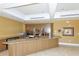 Spacious clubhouse area featuring a kitchenette, breakfast bar, granite countertops and tile flooring at 3070 Grand Bay Blvd # 644, Longboat Key, FL 34228