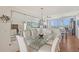 Formal dining room featuring a large glass table, comfortable seating, and modern accents at 3070 Grand Bay Blvd # 644, Longboat Key, FL 34228
