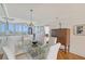 Formal dining room featuring a large glass table, comfortable seating, and stylish decor at 3070 Grand Bay Blvd # 644, Longboat Key, FL 34228