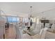 Open-concept dining room offering a great view of the ocean, featuring a glass table and seating for six at 3070 Grand Bay Blvd # 644, Longboat Key, FL 34228