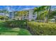 Beautiful exterior shot of this condo building, including entrance and meticulously maintained landscaping at 3070 Grand Bay Blvd # 644, Longboat Key, FL 34228