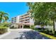 Beautiful exterior shot of this condo building, including entrance and meticulously maintained landscaping at 3070 Grand Bay Blvd # 644, Longboat Key, FL 34228