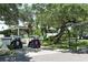 View of golf carts parked in front of Longboat Key Club in a beautiful and lush environment at 3070 Grand Bay Blvd # 644, Longboat Key, FL 34228