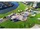 Aerial view of Longboat Key Club golf course featuring lush greenery, sand traps, and a serene lake at 3070 Grand Bay Blvd # 644, Longboat Key, FL 34228