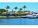Stunning waterfront homes with private docks and luxurious yachts under a clear blue sky at 3070 Grand Bay Blvd # 644, Longboat Key, FL 34228