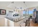 Bright kitchen features white cabinetry, granite countertops, stainless appliances and views at 3070 Grand Bay Blvd # 644, Longboat Key, FL 34228