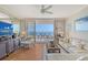 Bright living room featuring sliding glass doors to the balcony and comfortable seating arrangements at 3070 Grand Bay Blvd # 644, Longboat Key, FL 34228