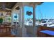 Relaxing outdoor dining area with beautiful marina views and seating with wooden tables and chairs at 3070 Grand Bay Blvd # 644, Longboat Key, FL 34228