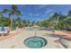 Community pool and spa area surrounded by lounge chairs, palm trees and beautifully landscaped grounds at 3070 Grand Bay Blvd # 644, Longboat Key, FL 34228
