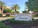 Elegant stone 'Grand Bay' entrance sign surrounded by lush landscaping and palm trees at 3070 Grand Bay Blvd # 644, Longboat Key, FL 34228