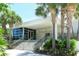 Exterior shot of tennis club entrance surrounded by palm trees and landscaping at 3070 Grand Bay Blvd # 644, Longboat Key, FL 34228