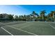 Beautifully maintained tennis court surrounded by lush greenery and palm trees at 3070 Grand Bay Blvd # 644, Longboat Key, FL 34228
