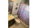Cozy bathroom featuring a patterned shower curtain, toilet, and vanity sink at 3231 Cambridge Dr, Sarasota, FL 34232