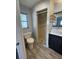 Well kept bathroom features a step in shower with wood look tiling and modern grey paint at 3231 Cambridge Dr, Sarasota, FL 34232