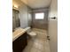 Bright bathroom with a bathtub, shower, vanity sink, and toilet, designed for modern living at 3231 Cambridge Dr, Sarasota, FL 34232