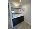Modern bathroom featuring double sinks, vanity, unique shelving, and plenty of light at 3231 Cambridge Dr, Sarasota, FL 34232