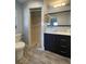 Well-lit bathroom featuring a stand-up shower, toilet, double sink vanity, and a modern design at 3231 Cambridge Dr, Sarasota, FL 34232