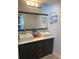 Contemporary bathroom with double sinks, vanity, large mirror, and unique round shelving at 3231 Cambridge Dr, Sarasota, FL 34232