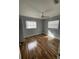 Inviting bedroom featuring hardwood floors, two windows for natural light, and a ceiling fan at 3231 Cambridge Dr, Sarasota, FL 34232