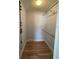 Walk-in closet with laminate floors and metal shelving for storage solutions at 3231 Cambridge Dr, Sarasota, FL 34232