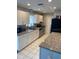 Well-lit kitchen featuring white cabinets, granite counters, and stainless steel appliances at 3231 Cambridge Dr, Sarasota, FL 34232
